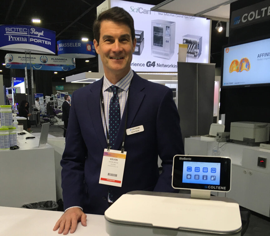 Kevin Boyle displays the BioSonic UC150 ultrasonic cleaning system in the Coltene booth.