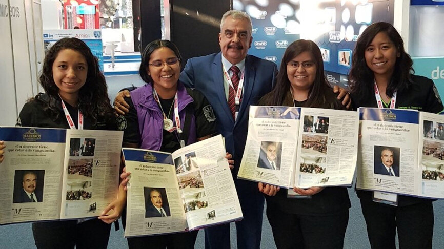 El Dr. Víctor Díaz Michel sostiene el ejemplar de Dental Tribune con su entrevista rodeado de sus estudiantes de UNAM.
