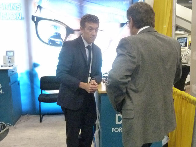 Designs for Vision’s Chris Gousios helps an attendee pick out the best lighting options.