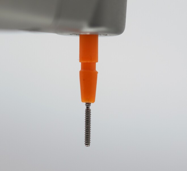 Fig. 5: Dentine pin mounted in the contra-angle handpiece before placement. 