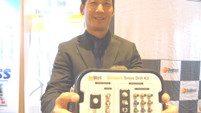 In the DoWell Dental Products booth, Terry Cha displays the Zirconia Sinus Drill Kit.