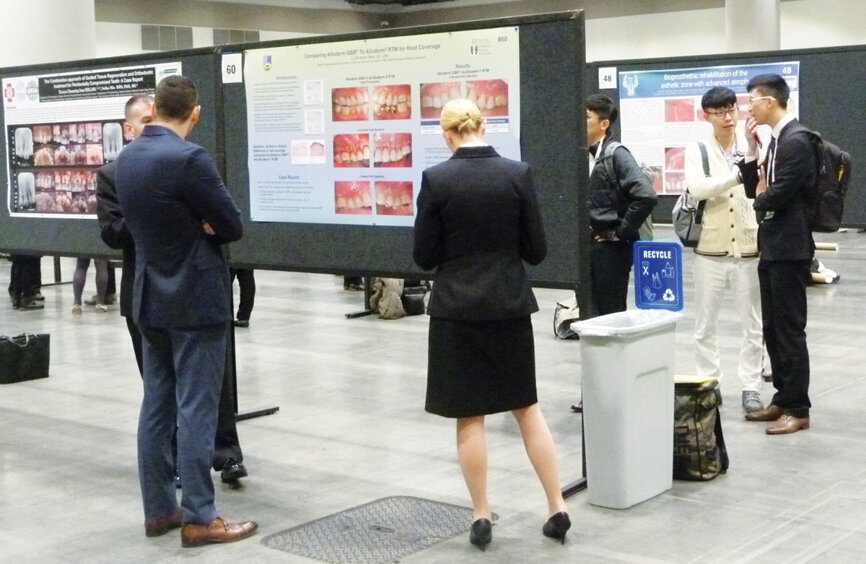 Attendees take time to look through the latest in perio studies at the ePoster session. (Photo: Sierra Rendon/DTA)