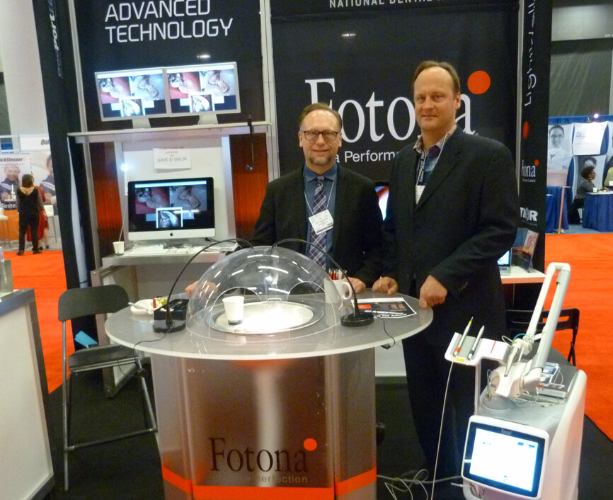 From left, brothers Neil and Clifford Magneson, in the National Dental Inc. booth are ready to help you try out the Fotona LightWalker dual wavelength laser. You can test it out on a real tooth.