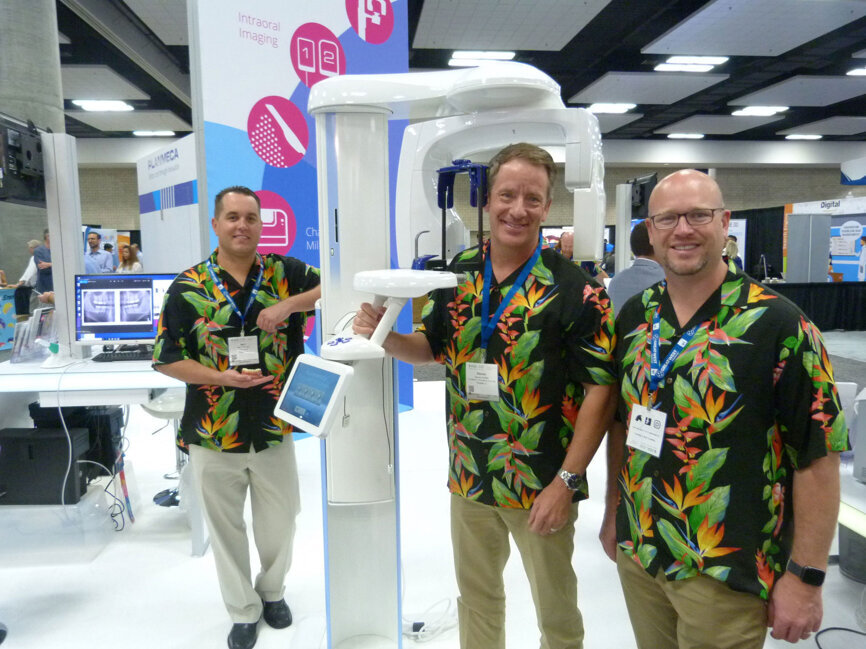 From left in the Planmeca booth, Neil Thomas, Steven Griffith and Brad Fine capture attention with their Hawaiian shirts and can show you how to capture incredibly detailed 2-D and 3-D images with the ProMax 3D Classic. (Photo: Robert Selleck/DTA)