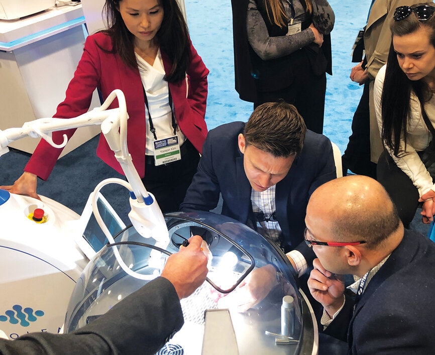 Aaron Shumaker of Convergent Dental demonstrates the Solea all-tissue laser at the Patterson booth.