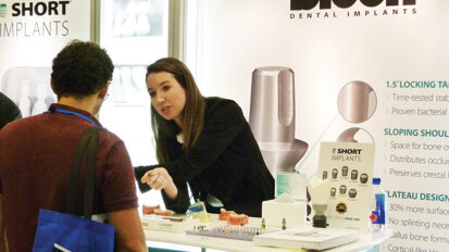 Taylor Ellis speaks with an attendee at the Bicon booth. Photo by Sierra Rendon/DTA