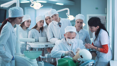 Are haptic dental trainers better than phantom heads for dental curricula?