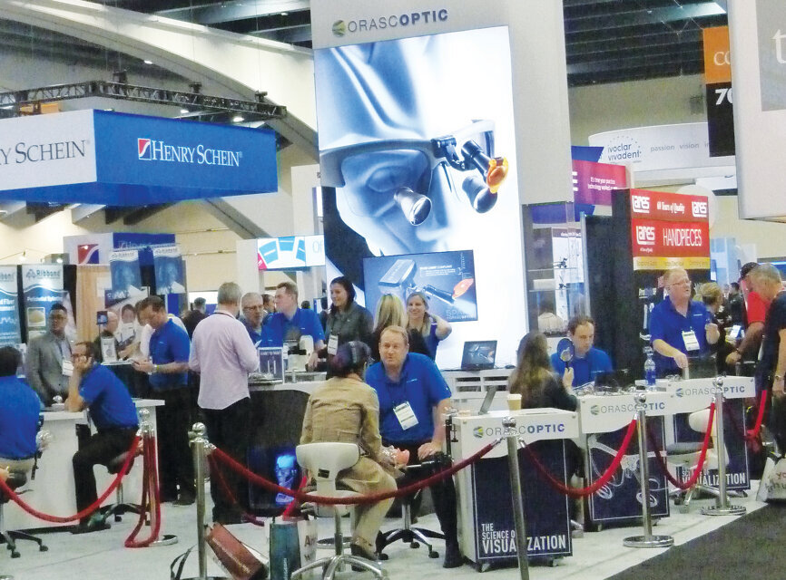 The Orascoptic booth stays busy in the exhibit hall (Photo: Sierra Rendon, DTA).