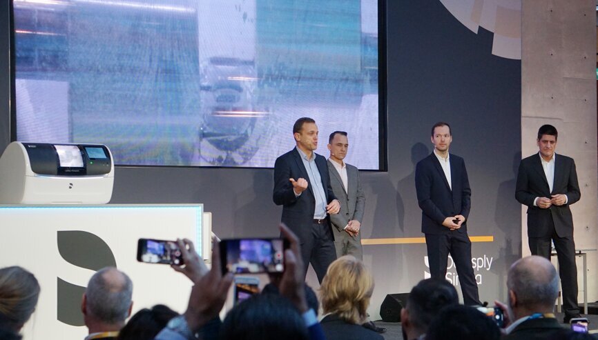 Aaron Dayringer (left), Global Product Manager CAD/CA at Dentsply Sirona, demonstrated the milling of a crown. (Image: Dental Tribune International)