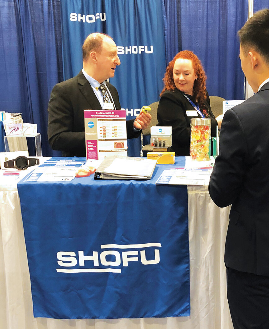 David Goldshaw and Sarah Bermel of Shofu show off the company’s newest equipment.