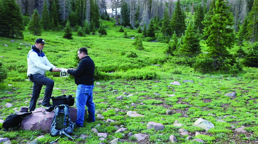 Brown and Webb prep the drone to fly over the landing zone.