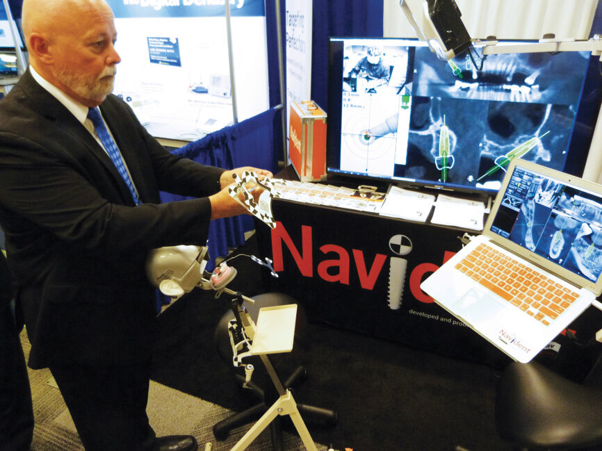 Darrell Cook at ClaroNav prepares to demonstrate the company’s surgical navigation solutions to attendees. Photo by Sierra Rendon/DTA