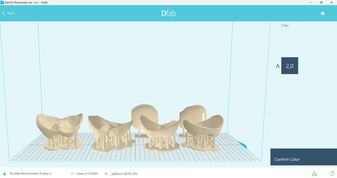 Figs. 4a–d: STL files of the restorations on the build platform as seen in the Photoshade orientation, nesting and colour gradient-setting software.