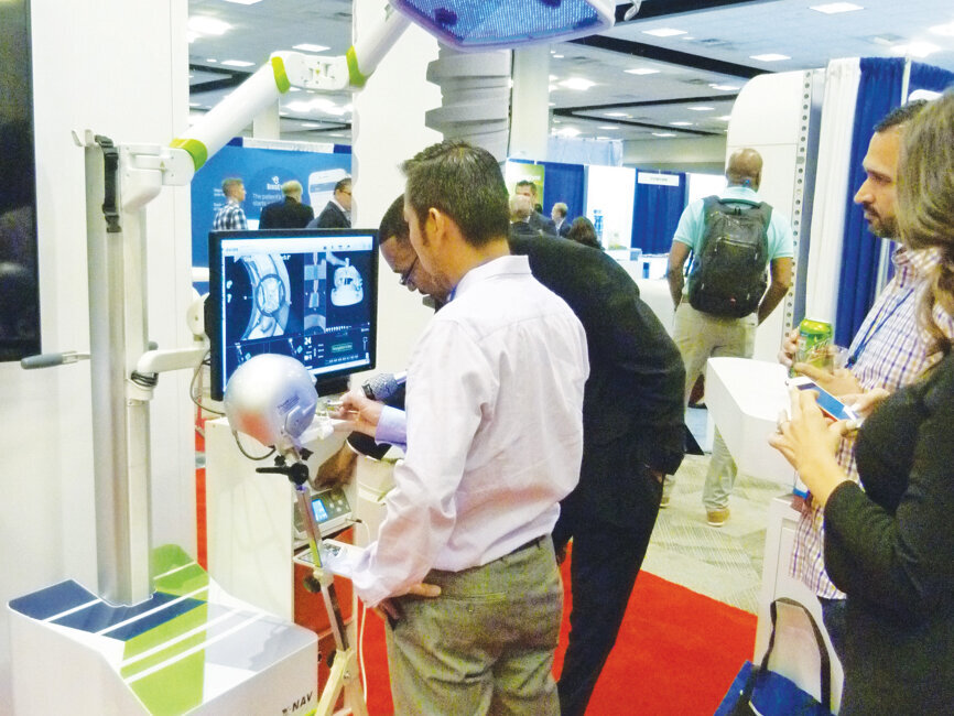 Jamal Matthews of Nobel Biocare demonstrates the benefits of X-Nav Technology. Photo by Sierra Rendon/DTA