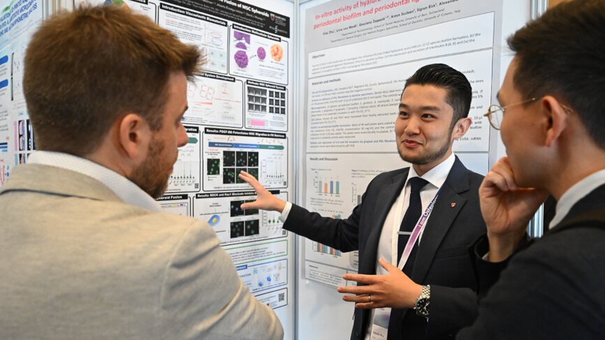 Dr David Wu (centre) during the event’s poster exhibition and research networking day. (Image: Osteology Foundation) 