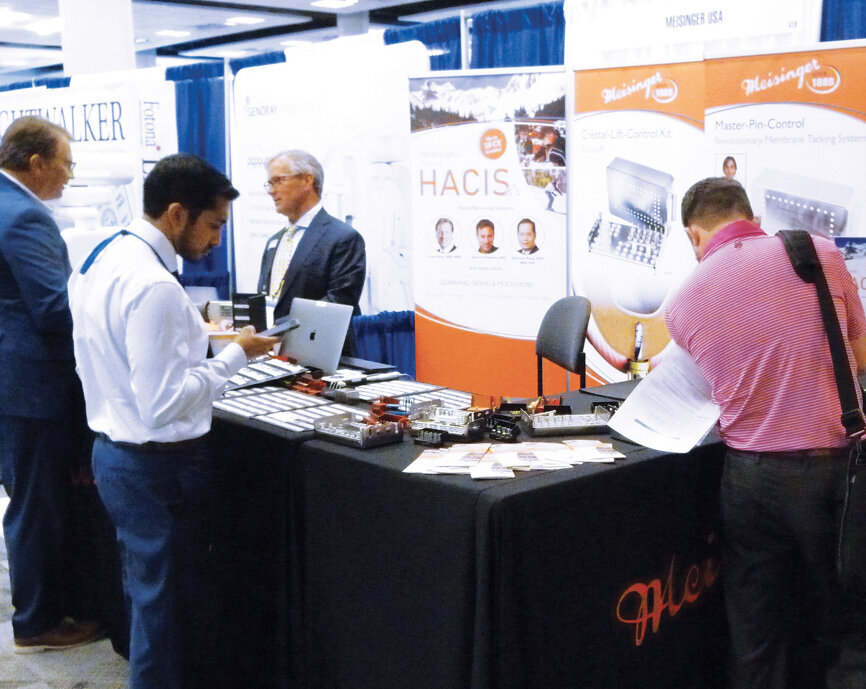 Meisinger President Alex Miller speaks to attendees at the company’s busy booth. Photo by Sierra Rendon/DTA