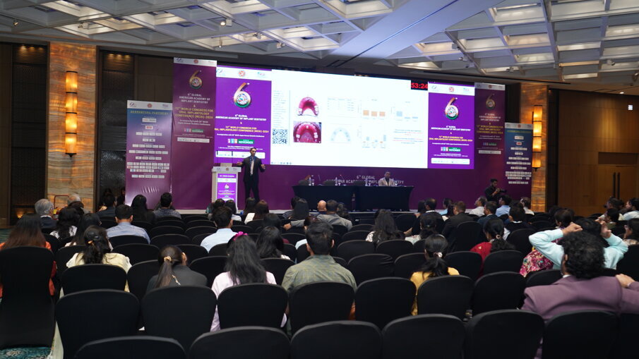 Dr. Varun Acharya addressing a house full on digital impressions in implant prosthetics