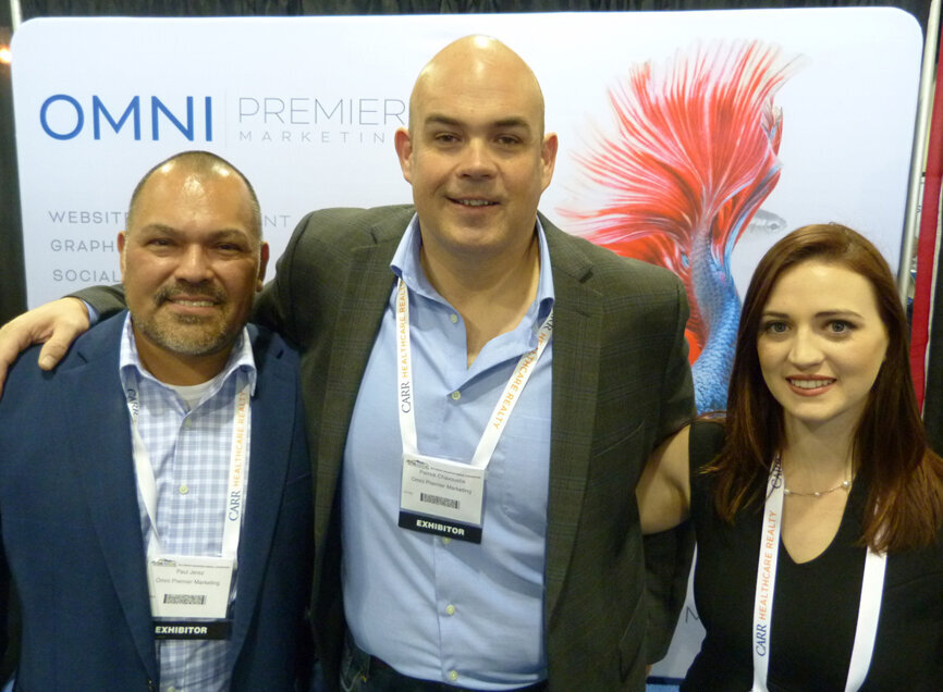 From left in the Omni Premier Marketing booth, Paul Jerez; Patrick Chavoustie, founder and president; and  Kaitlynne Tatum. (Photo: Robert Selleck/Dental Tribune America)