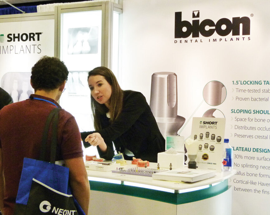 Taylor Ellis speaks with an attendee at the Bicon booth. Photo by Sierra Rendon/DTA