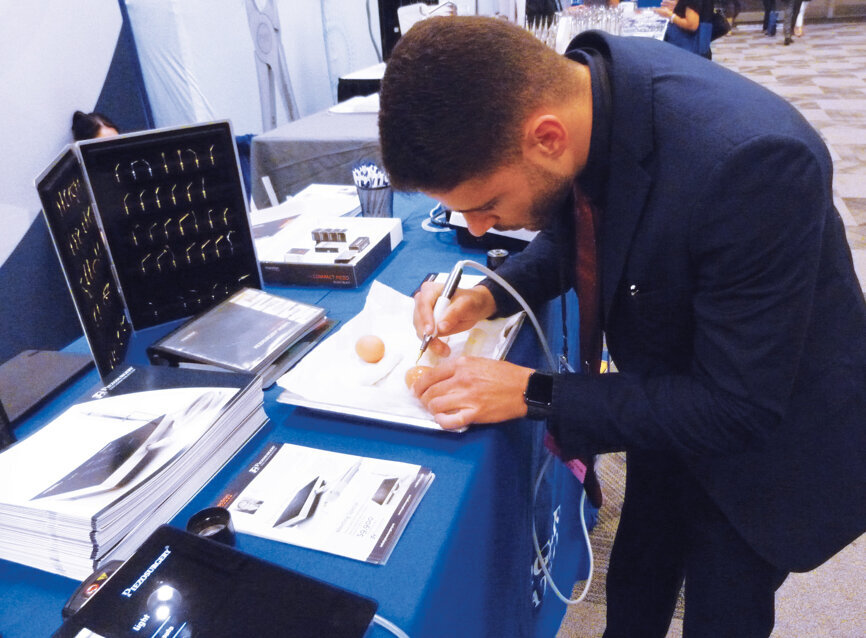 Thiago Alves of Piezosurgery Inc. demonstrates the precision offered by the company’s advanced technology. Photo by Sierra Rendon/DTA