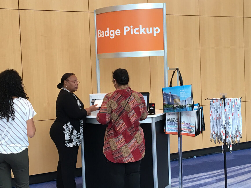 An attendee picks up her badge before joining the action on the first day of the AGD2019.