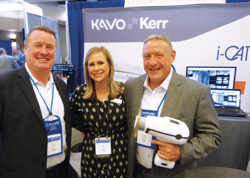 From left, Dan Carmody, Liz Weber and Mark Freedman show off innovative equipment at the Kavo Kerr booth. Photo by Sierra Rendon/DTA
